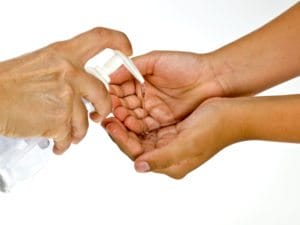 Hand sanitizer being squeezed onto hands. Do hand sanitizers protect allergic children?